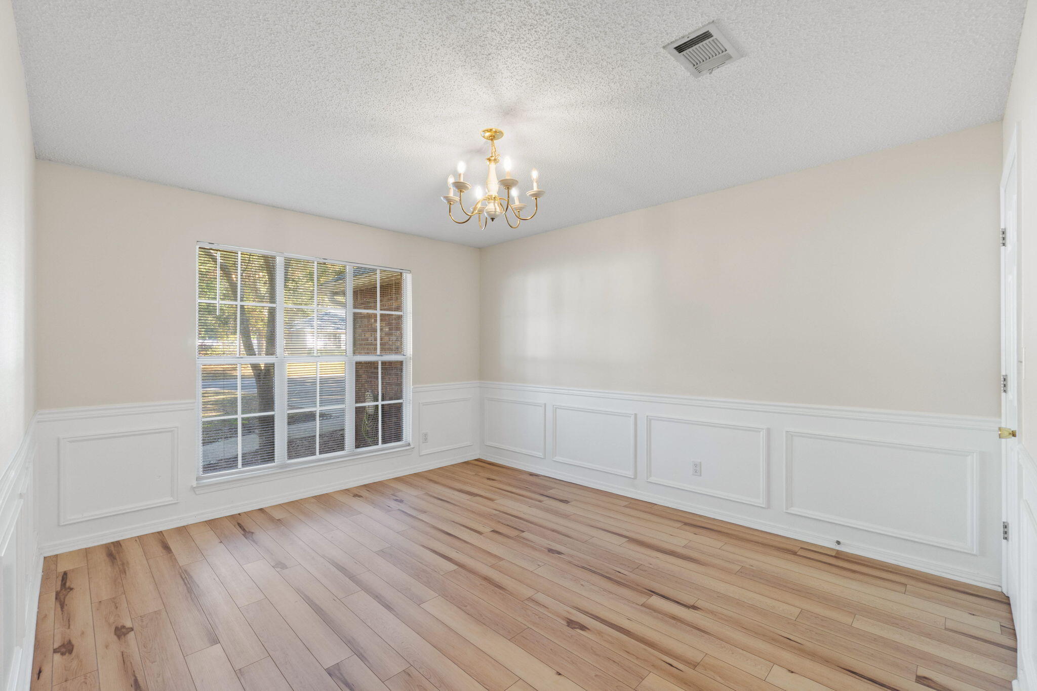 4591 Scarlet Drive Crestview, FL 32539 - Photo 15 of 37 wooden floor in an empty room with a window