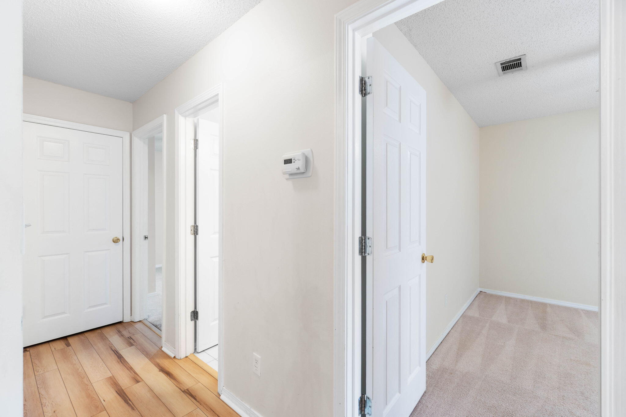 4591 Scarlet Drive Crestview, FL 32539 - Photo 17 of 37 a view of a hallway with wooden floor and closet area