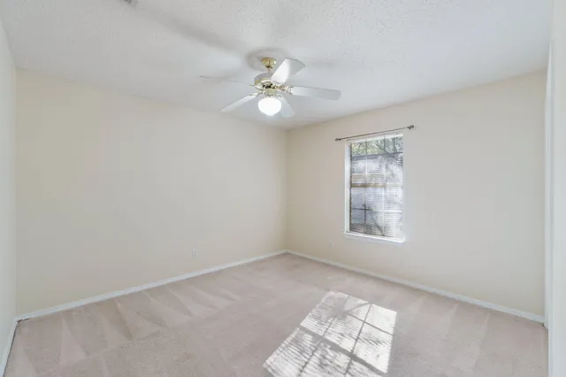 a view of a big room with chandelier fan