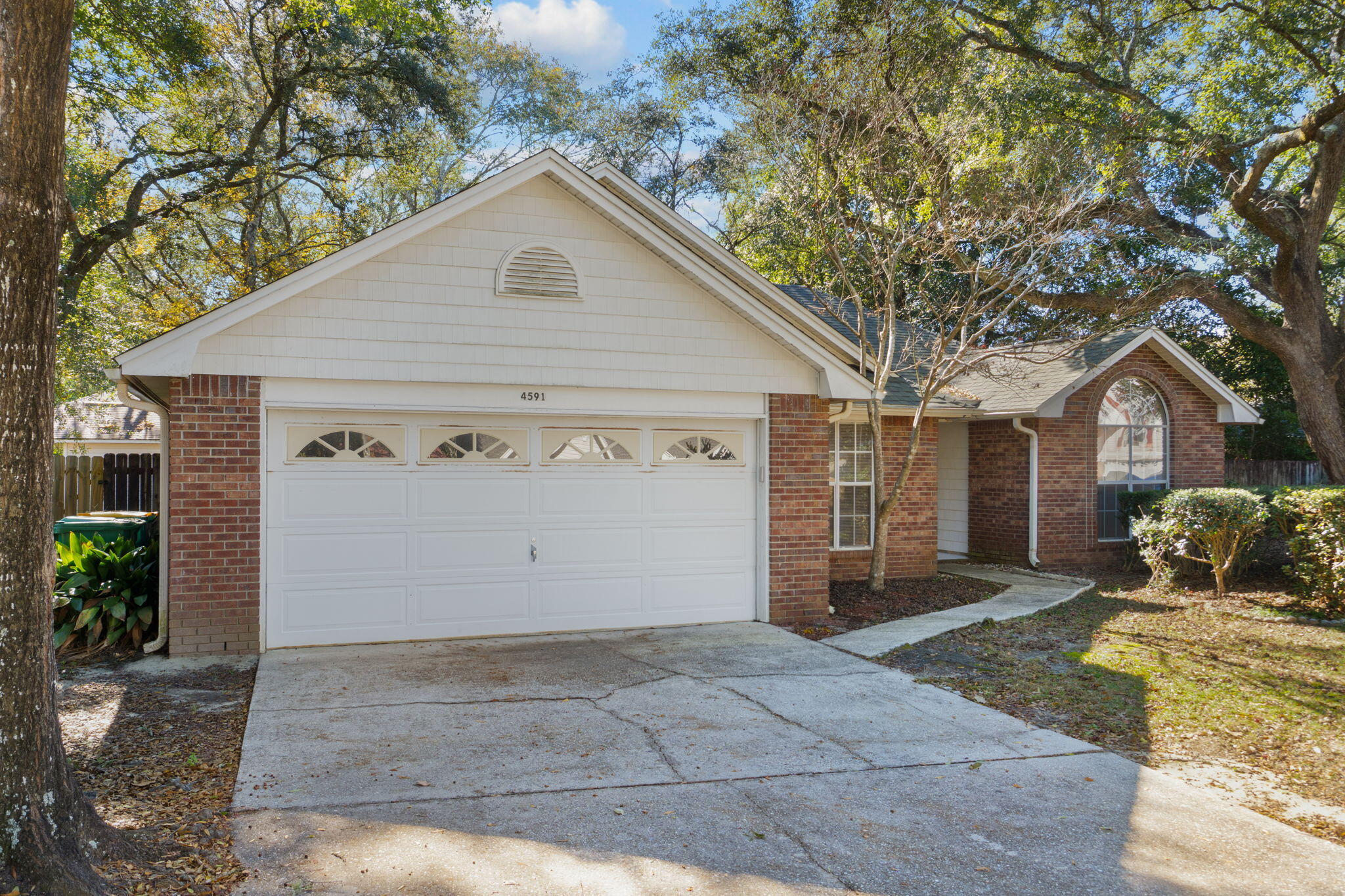 4591 Scarlet Drive Crestview, FL 32539 - Photo 2 of 37 a view of a house with a yard and garage