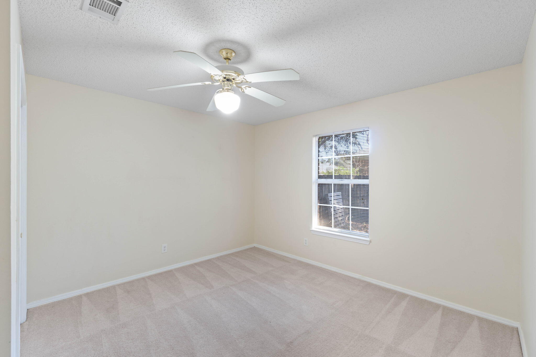 4591 Scarlet Drive Crestview, FL 32539 - Photo 21 of 37 an empty room with windows and fan