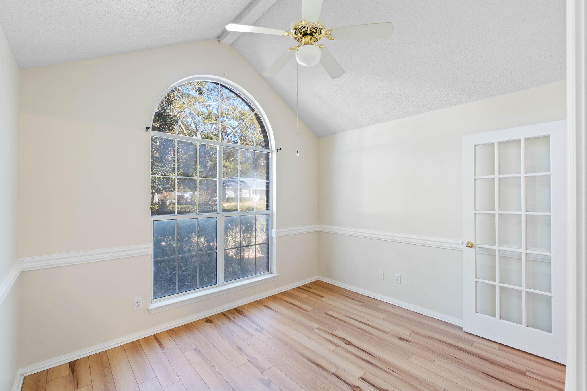 4591 Scarlet Drive Crestview, FL 32539 - Photo 25 of 37 an empty room with wooden floor fan and windows