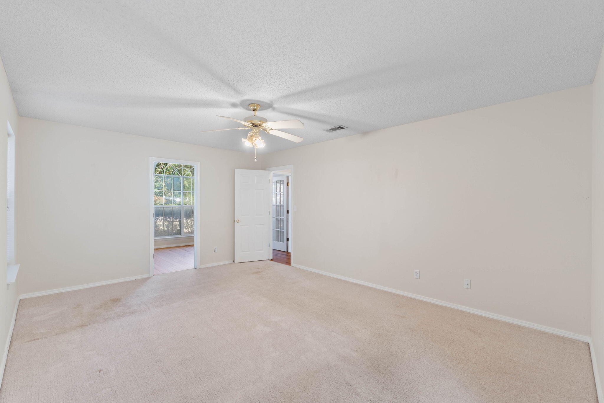 4591 Scarlet Drive Crestview, FL 32539 - Photo 28 of 37 a view of an empty room with a ceiling fan