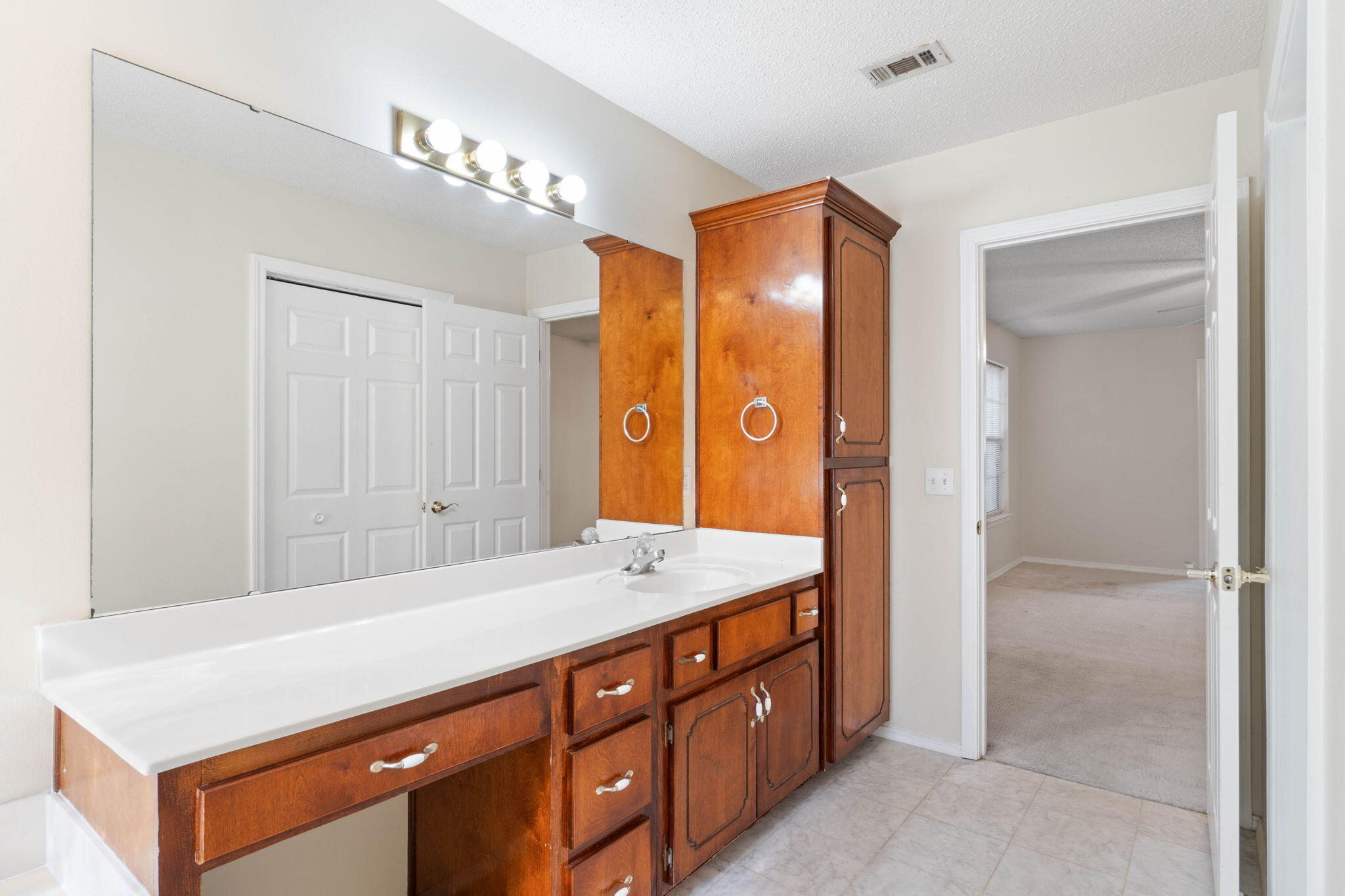 4591 Scarlet Drive Crestview, FL 32539 - Photo 31 of 37 a bathroom with a sink a vanity and a mirror