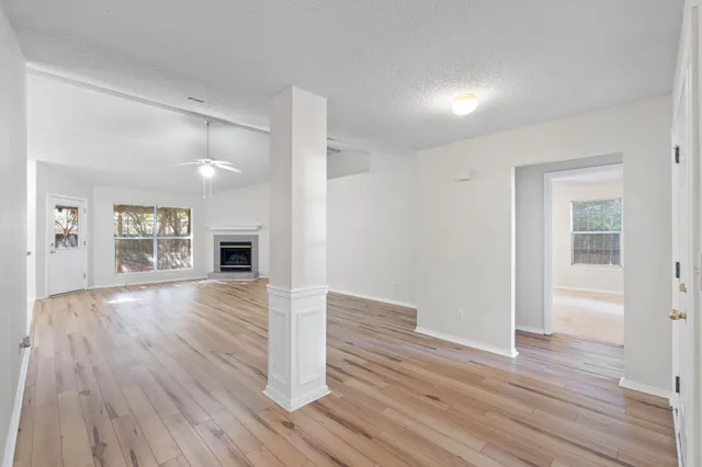 wooden floor in an empty room with a window
