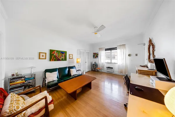 a bedroom with furniture and a wooden floor
