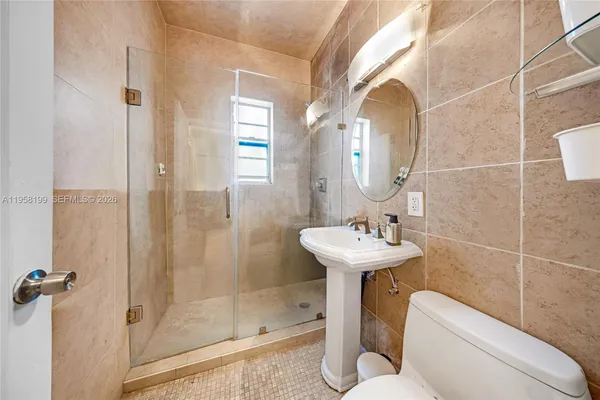 a bathroom with a sink toilet and shower