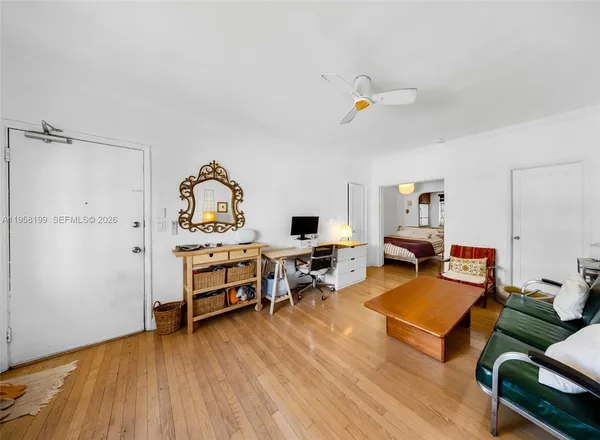 a living room with furniture and wooden floor
