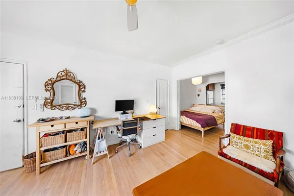 a living room with furniture a flat screen tv and a table
