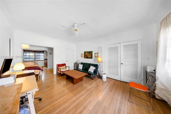 a living room with furniture and wooden floor