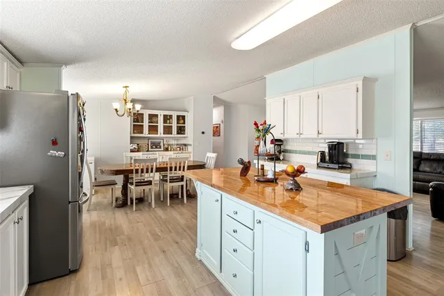 a kitchen with a sink refrigerator and cabinets