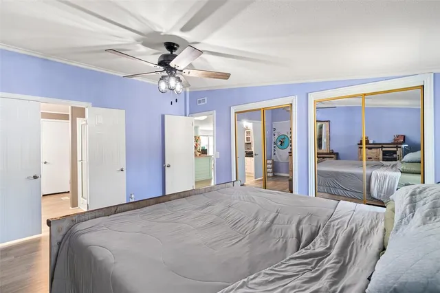 a large bedroom with a large bed and a chandelier