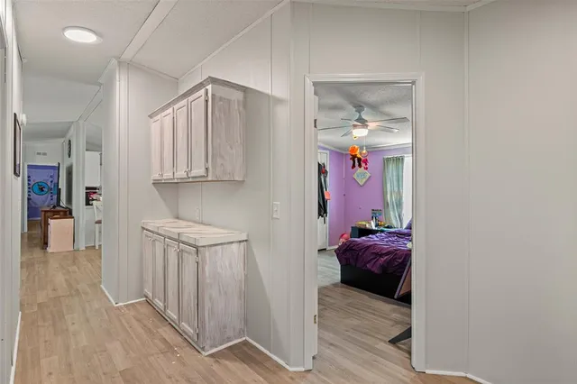 a hallway with a couch and chandelier