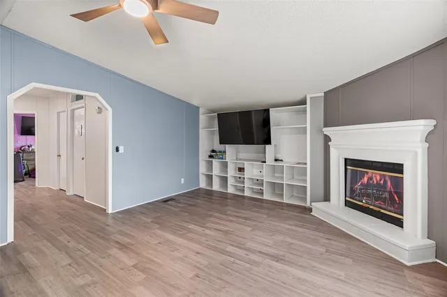 a view of a livingroom with an empty space and a fireplace