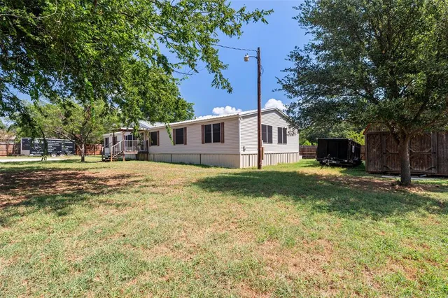 a front view of a house with a yard and a garage