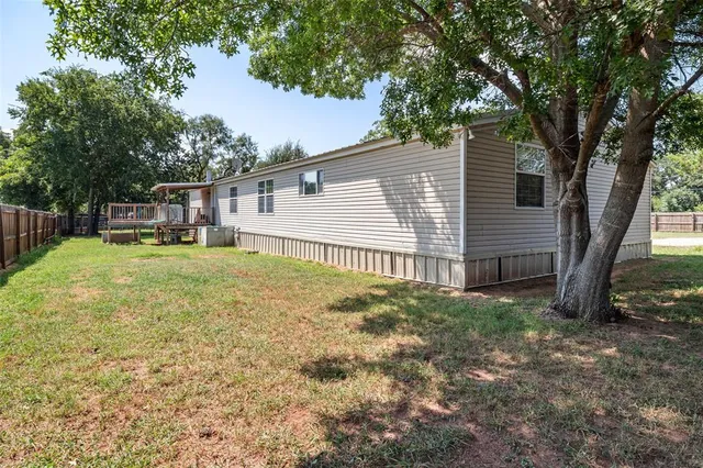 a backyard of a house with table and chairs