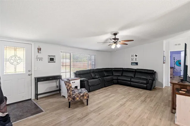 a living room with furniture and wooden floor