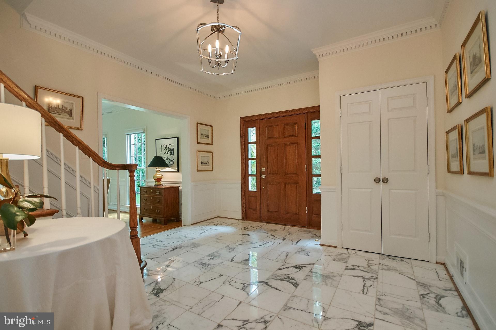 Foyer with Marble Tile and Extensive Molding