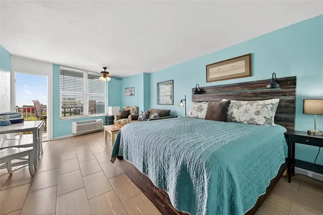 a living room with furniture and painting on the wall