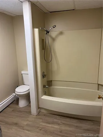 a bathroom with a toilet and a bathtub