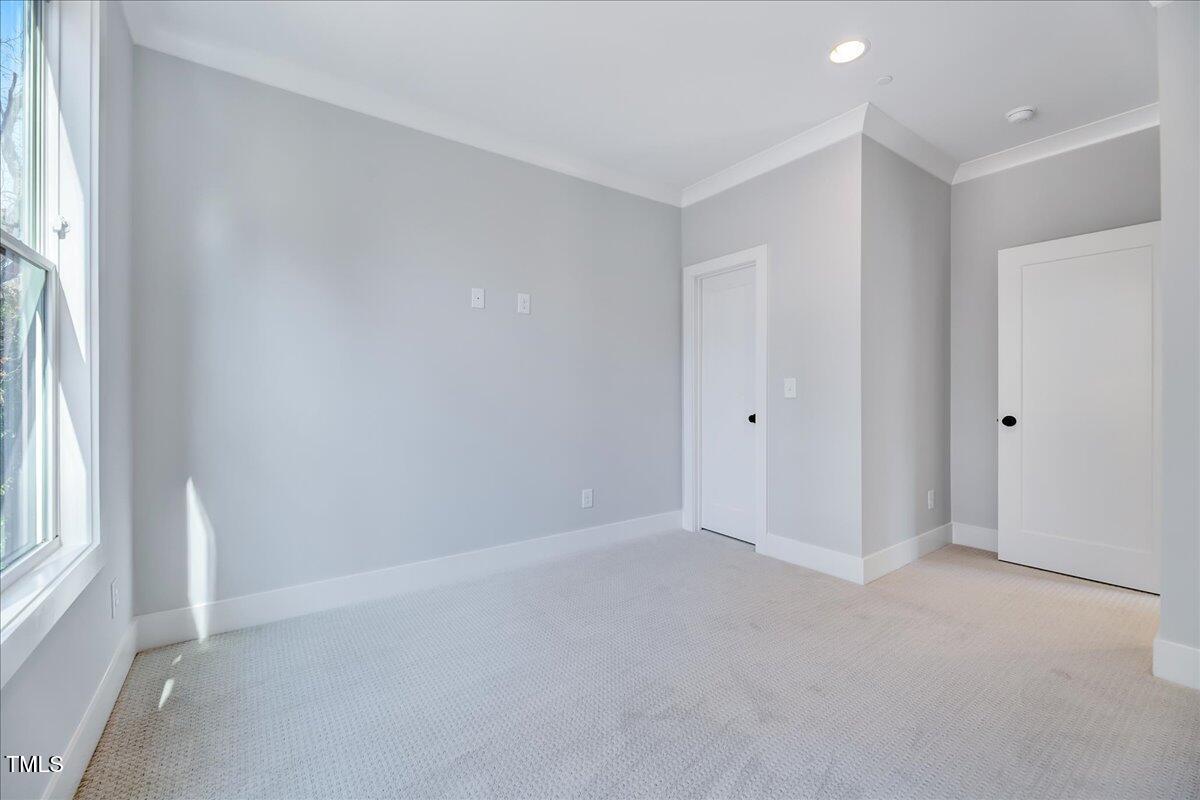 811 Maple Berry Lane, Unit 106 Raleigh, NC 27607 - Photo 17 of 30 a view of an empty room with a window