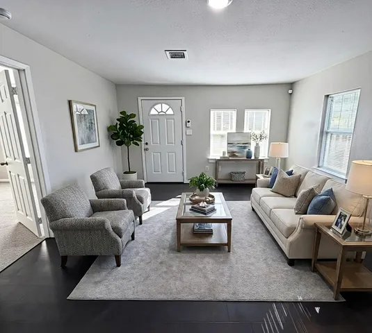 a living room with furniture and a large window