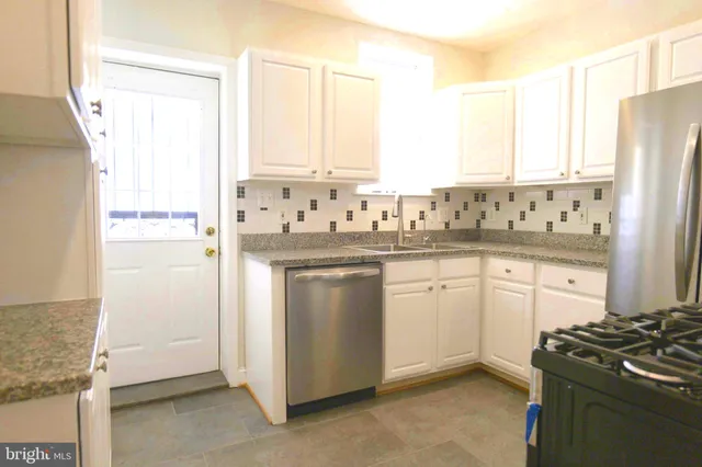 a kitchen with a sink stove and refrigerator