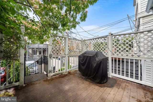 a view of a porch with wooden floor and fence