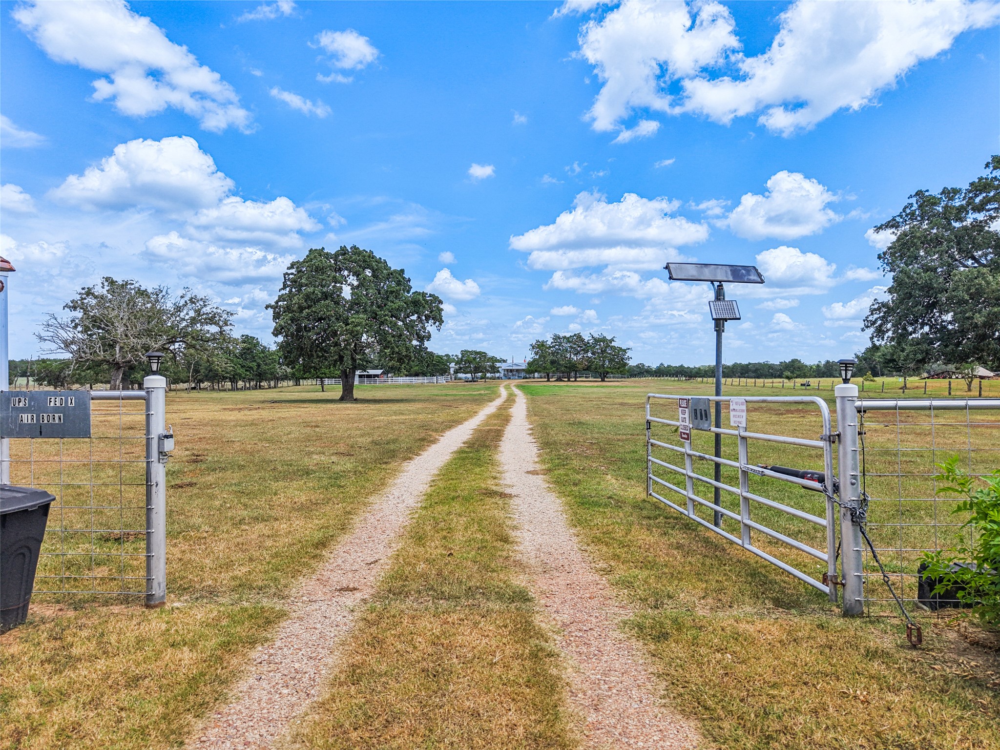 372 Hofferek Road Rosanky, TX 78953 - Photo 34 of 40 View of dirt / gravel road with a gate, a gated entry, and a rural view