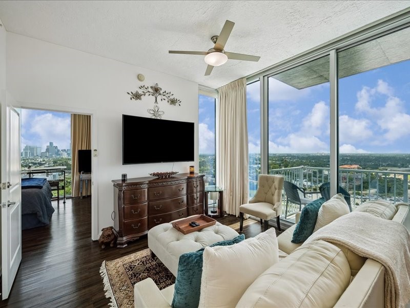 5925 Almeda Road, Unit 11901 Houston, TX 77004 - Photo 4 of 36 Wake up to breathtaking panoramic views of Houston’s skyline from this elegant living room. Expansive windows create a dramatic backdrop while filling the space with sunlight. The thoughtful layout offers plenty of room for relaxing, entertaining, and enjoying the vibrant cityscape both day and night.