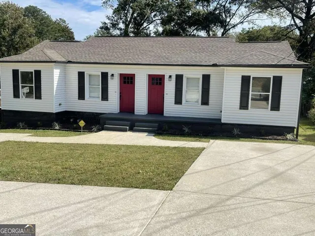 a front view of a house with a yard