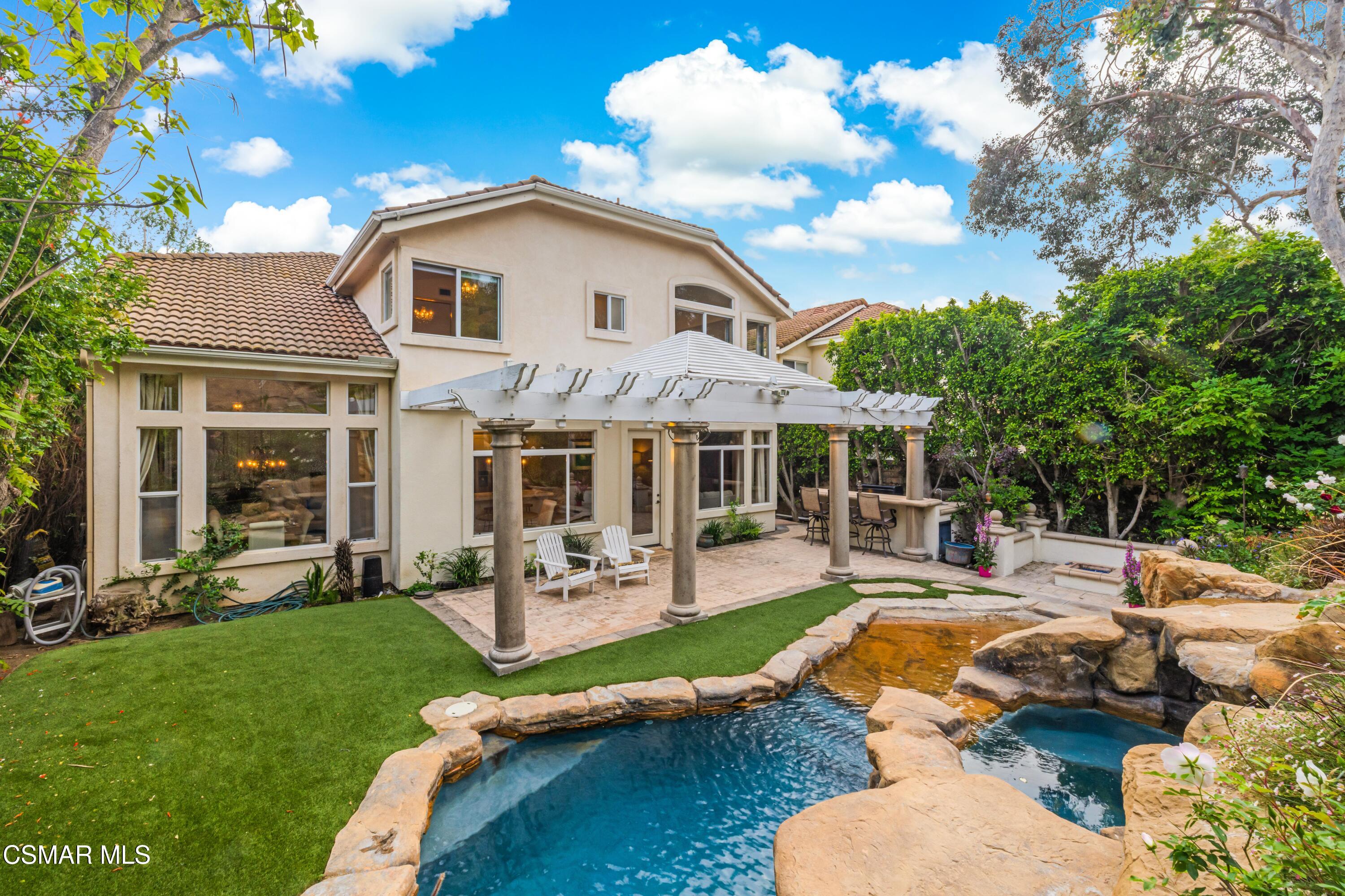 a view of a house with swimming pool and porch with furniture