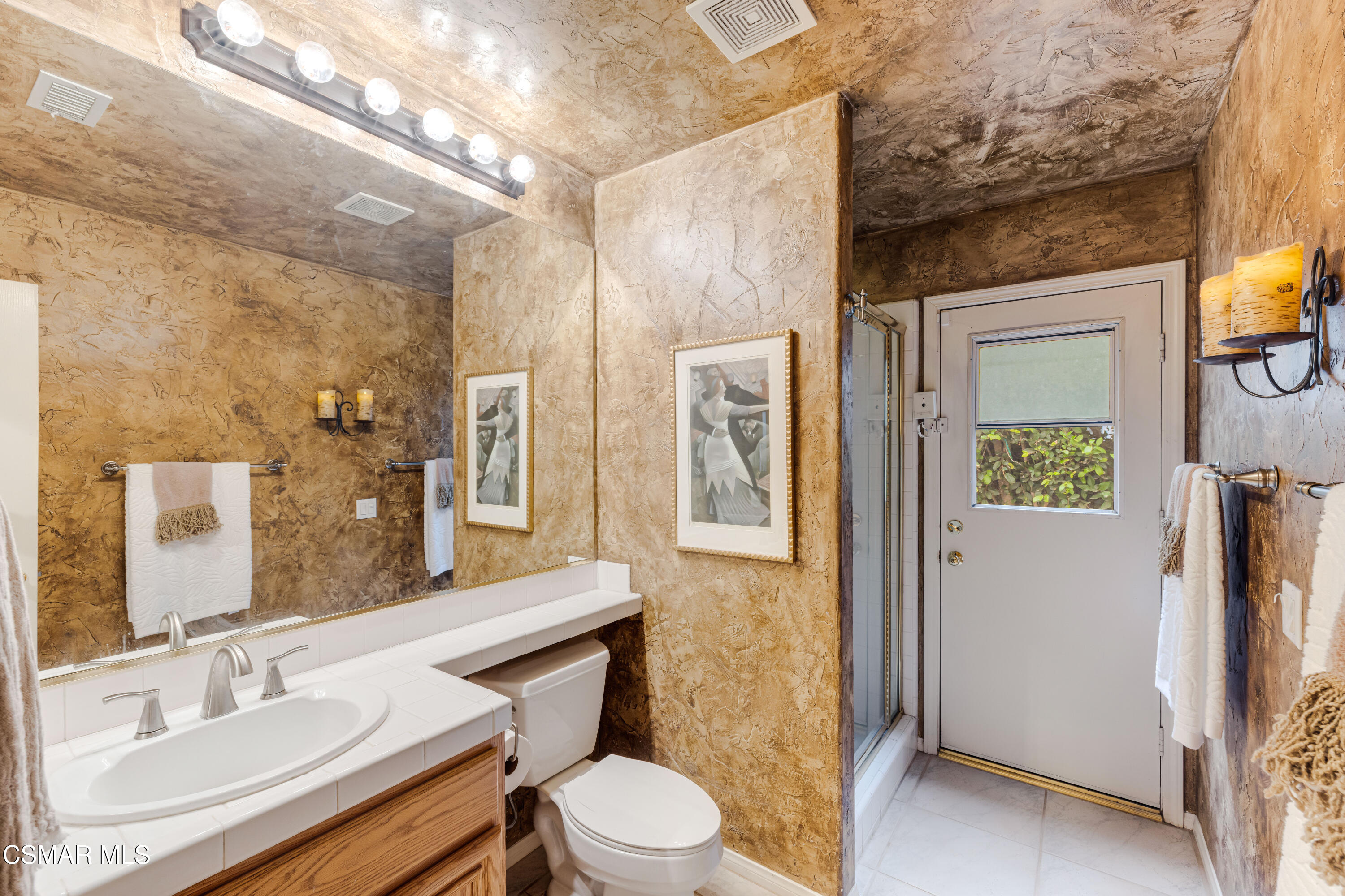 15633 Harte Lane Moorpark, CA 93021 - Photo 18 of 64 a bathroom with a sink a toilet a mirror and shower