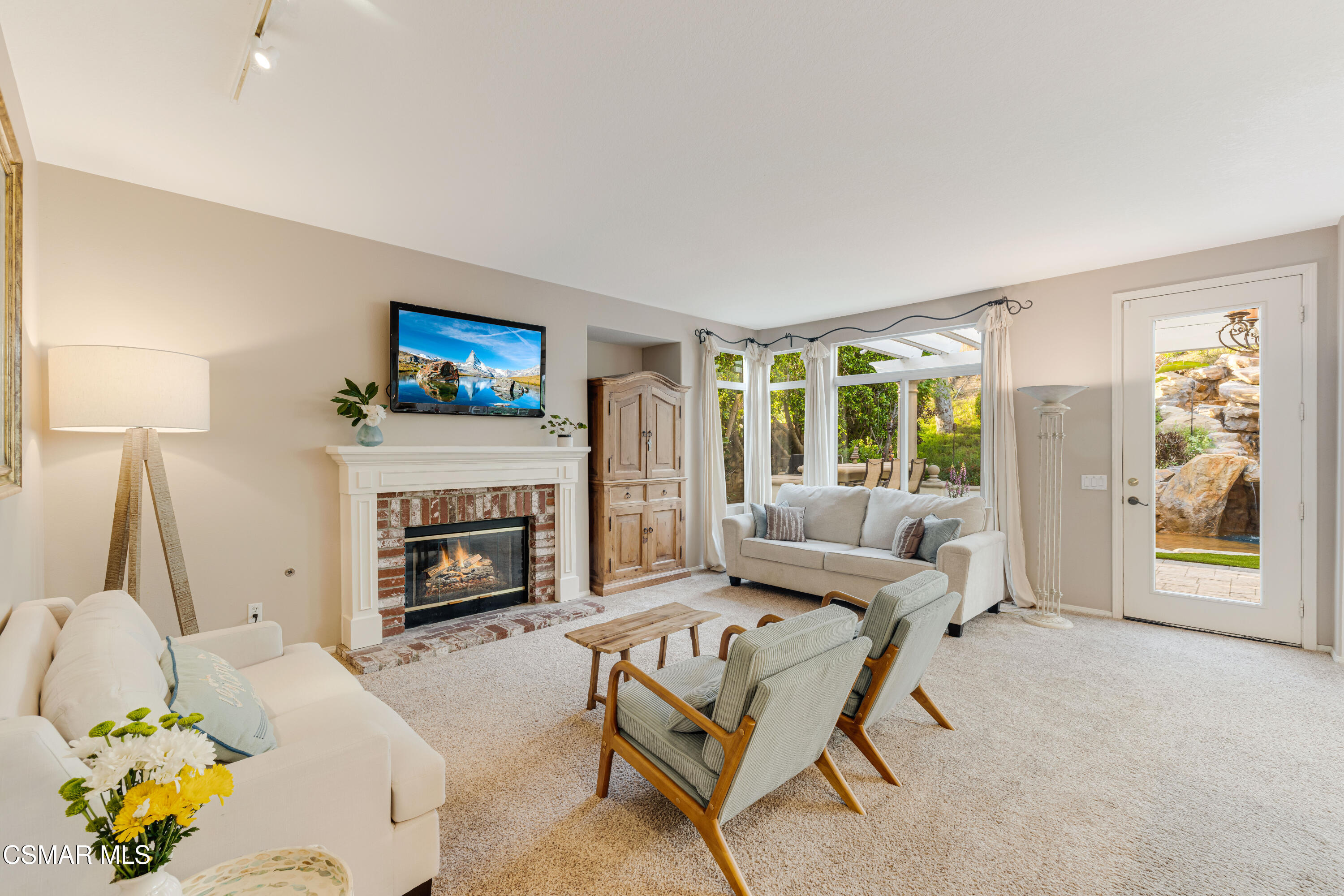 15633 Harte Lane Moorpark, CA 93021 - Photo 19 of 64 a living room with furniture a fireplace and a flat screen tv