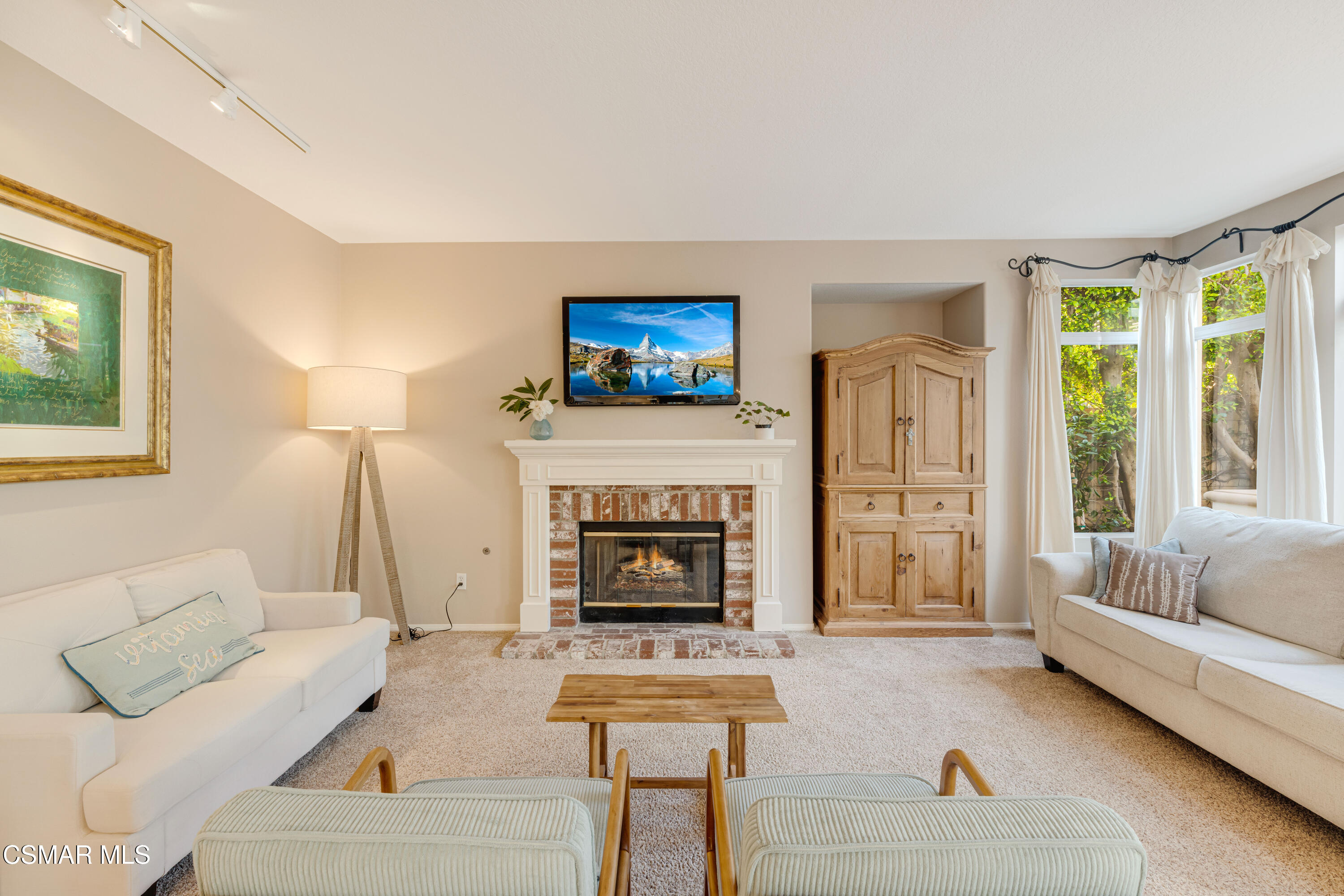 15633 Harte Lane Moorpark, CA 93021 - Photo 20 of 64 a living room with furniture a fireplace and a flat screen tv