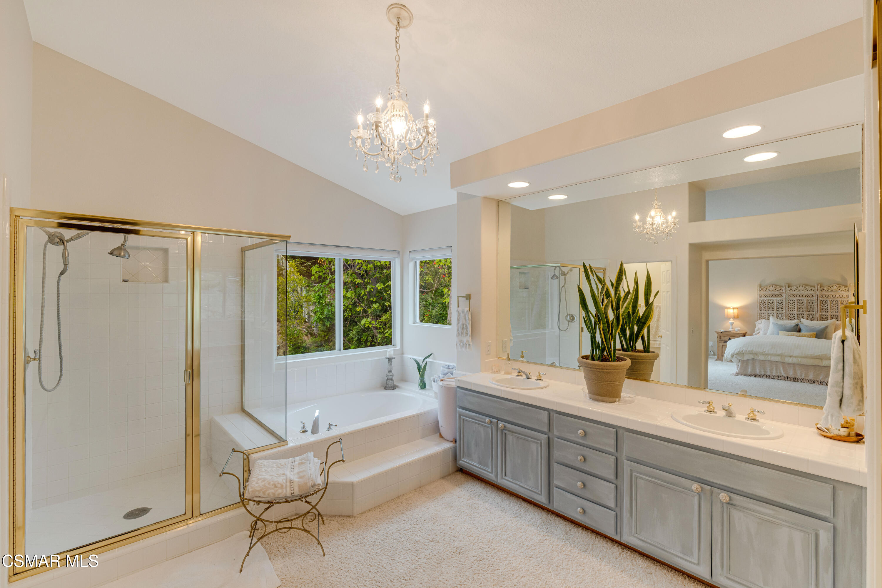15633 Harte Lane Moorpark, CA 93021 - Photo 38 of 64 a spacious bathroom with a double vanity sink a large mirror and a bathtub