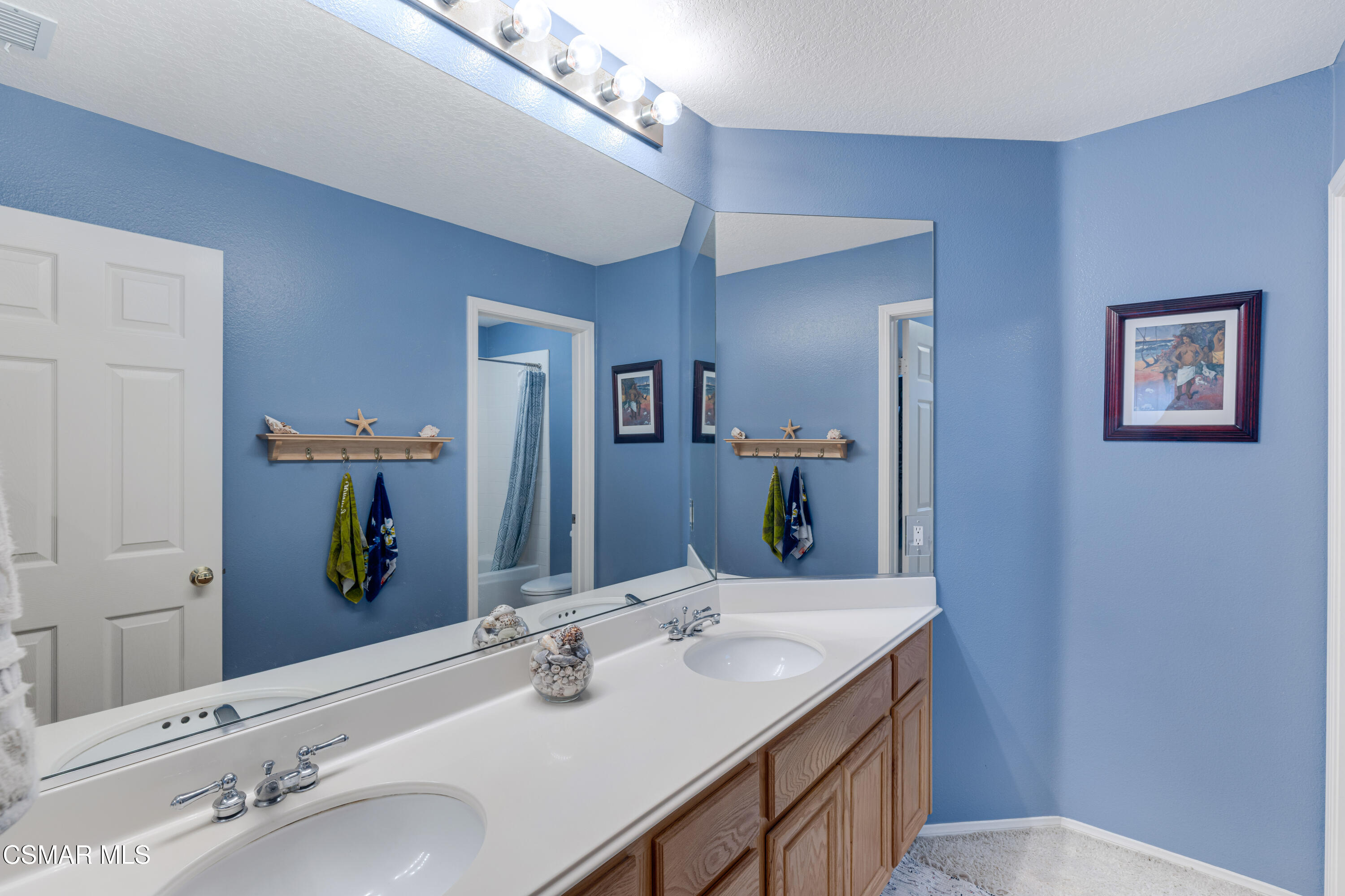 15633 Harte Lane Moorpark, CA 93021 - Photo 43 of 64 a bathroom with a double vanity sink and a mirror