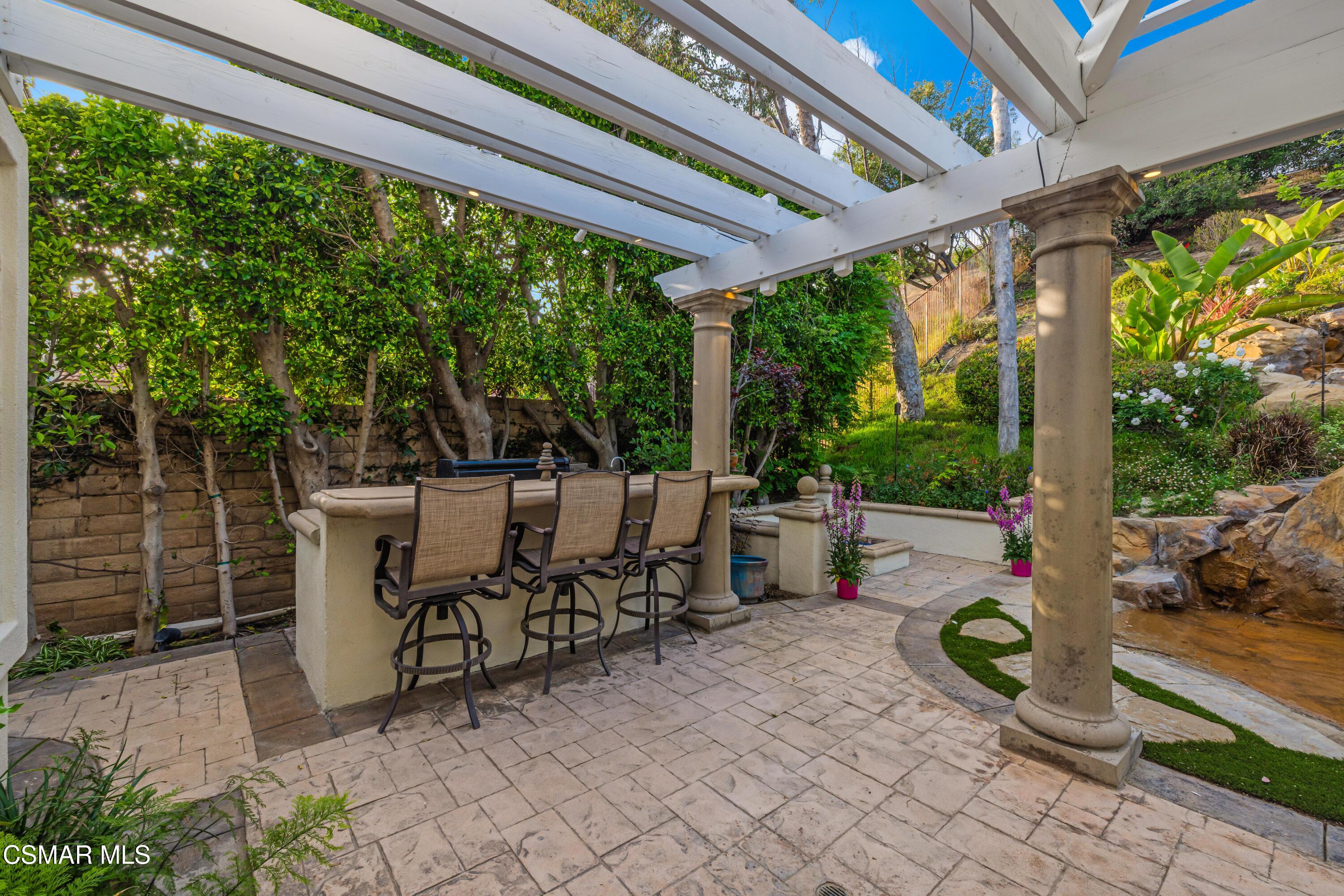 15633 Harte Lane Moorpark, CA 93021 - Photo 45 of 64 a view of a patio with table and chairs potted plants with floor to ceiling window