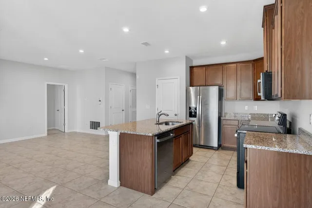 a view of a room with a large window and front door