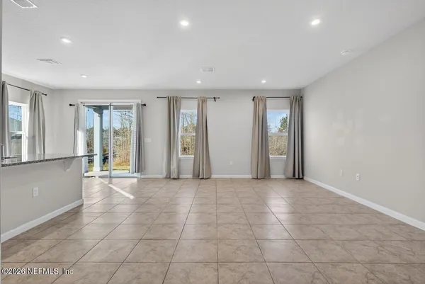 a view of an empty room with glass door