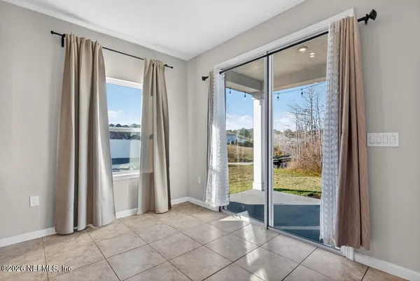 a view of a room with a large window and front door