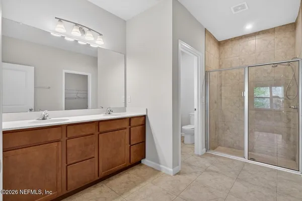 a bathroom with a double vanity sink and a mirror