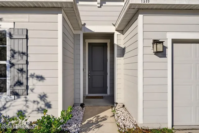 a view of a hallway with closet and a living room