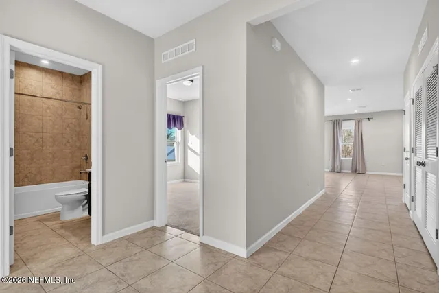 a kitchen with stainless steel appliances granite countertop a stove top oven a sink and a refrigerator with wooden floor