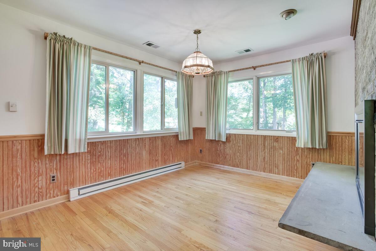 2645 Aspen Road Port Republic, MD 20676 - Photo 13 of 51 a view of an empty room with wooden floor and a window
