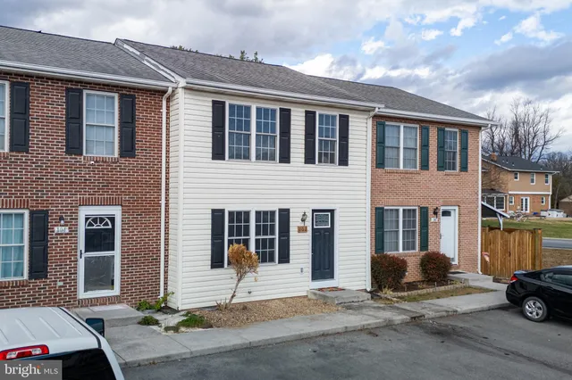 a building with car parked in front of it