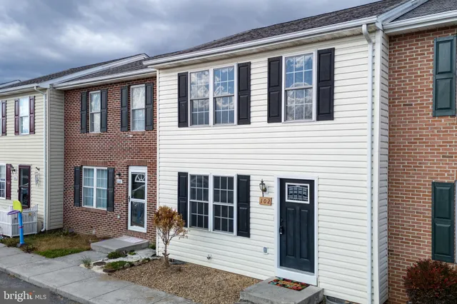 a front view of a house with outdoor seating