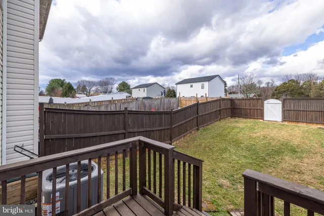 a view of a balcony with wooden floor and fence