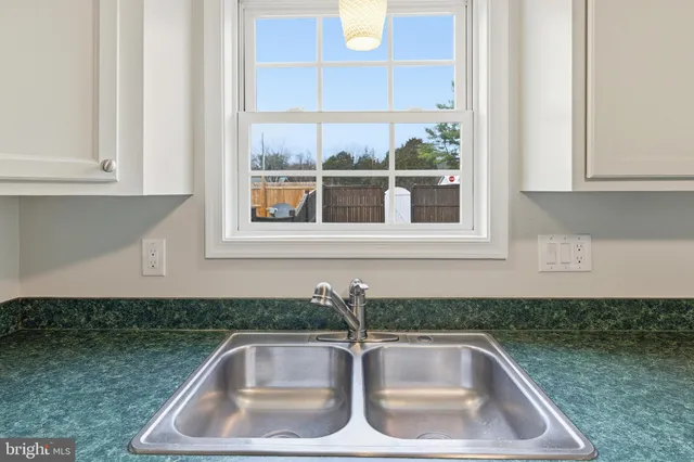 a kitchen with granite countertop a sink and a window
