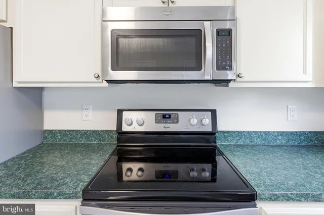 a stove top oven sitting inside of a kitchen
